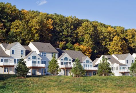 Houses in rural PA with trees during fall season.